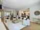 Bright, open-concept living room features hardwood floors, modern furniture, and seamless flow into the kitchen at 195 Prestwick Ct, Summerville, SC 29483