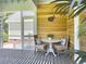 Screened porch features wood paneling and seating with a view of the house's exterior at 195 Prestwick Ct, Summerville, SC 29483