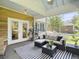 Inviting screened porch with seating, a ceiling fan, and French door entry at 195 Prestwick Ct, Summerville, SC 29483
