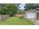 View of backyard with lush lawn, privacy fence, and attached garage at 212 Kentucky Dr, Ladson, SC 29456