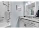 Bright bathroom featuring granite countertop, white cabinets, and shower with marble tile surround at 212 Kentucky Dr, Ladson, SC 29456