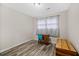 Cozy bedroom with wood-look floors, neutral walls, and a vintage desk with chair at 212 Kentucky Dr, Ladson, SC 29456