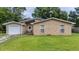 Charming single-story brick home with well-manicured lawn and attached garage on a tree-lined street at 212 Kentucky Dr, Ladson, SC 29456