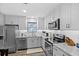 Bright kitchen featuring stainless appliances, gray cabinets, and granite countertops at 212 Kentucky Dr, Ladson, SC 29456