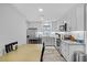 Well-lit kitchen with stainless steel appliances, gray cabinets, and wood grain flooring at 212 Kentucky Dr, Ladson, SC 29456