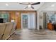 Comfortable living room with sliding glass doors, wood paneling, and sleek flooring at 212 Kentucky Dr, Ladson, SC 29456