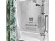 Shower area with marble tile surround, built-in niche, handheld sprayer, and grab bars at 212 Kentucky Dr, Ladson, SC 29456
