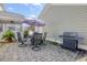 The backyard features a brick patio with a grill, patio set, and an umbrella at 213 Crossandra Ave, Summerville, SC 29483