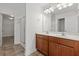 Bathroom with double sink vanity featuring wood cabinets and a tile floor at 213 Crossandra Ave, Summerville, SC 29483
