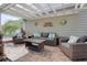 The covered patio has wicker furniture with cushions and decorative fish wall hangings at 213 Crossandra Ave, Summerville, SC 29483