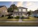 Charming two-story home with palm trees and landscaped front yard at sunset at 213 Crossandra Ave, Summerville, SC 29483