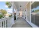 View of covered front porch with white columns, a railing, and a view of the front yard at 213 Crossandra Ave, Summerville, SC 29483