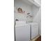 A laundry room with a washer and dryer and shelf on the wall for storage at 213 Crossandra Ave, Summerville, SC 29483