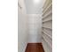 View of the pantry with white walls, wood floors, and wire shelving and vertical wood shelving at 213 Crossandra Ave, Summerville, SC 29483