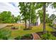Large backyard with mature trees, fire pit, patio furniture, and privacy fence at 217 7Th Ave, Mount Pleasant, SC 29464