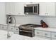 Well-equipped kitchen with stainless steel appliances, tile backsplash, and countertop sink and fixtures at 217 7Th Ave, Mount Pleasant, SC 29464