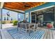 A beautiful outdoor space featuring covered dining and screened in seating areas and a grill at 2219 Kemmerlin St, Johns Island, SC 29455