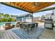 An outdoor entertaining area with a pool, dining table, and lounge chairs under a covered ceiling at 2219 Kemmerlin St, Johns Island, SC 29455