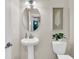Stylish powder room features a pedestal sink, oval mirror, and decorative accents for a modern, elegant feel at 2219 Kemmerlin St, Johns Island, SC 29455