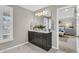 Bright bathroom featuring a double sink vanity, decorative mirror and access to the main bedroom at 2219 Kemmerlin St, Johns Island, SC 29455