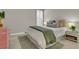A cozy bedroom with a plush bed, decorative pillows, and shuttered window at 2219 Kemmerlin St, Johns Island, SC 29455
