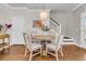 Dining area with modern chandelier, round table, four chairs, and a view of the staircase at 2219 Kemmerlin St, Johns Island, SC 29455