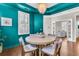Chic dining room featuring a stylish light fixture, round table, and unique teal-colored walls at 2219 Kemmerlin St, Johns Island, SC 29455