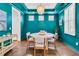 Elegant dining area features a round table, stylish chairs, and unique teal walls for a contemporary feel at 2219 Kemmerlin St, Johns Island, SC 29455