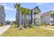 Charming two-story home with a well-manicured lawn, landscaping, and a double porch at 2219 Kemmerlin St, Johns Island, SC 29455