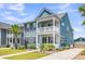 Charming two-story home featuring double balconies, a landscaped yard, and vibrant curb appeal at 2219 Kemmerlin St, Johns Island, SC 29455