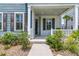 Inviting front porch with manicured landscaping and a charming entrance to this beautiful home at 2219 Kemmerlin St, Johns Island, SC 29455