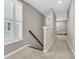 Upstairs hallway with neutral walls, carpet, a window with shutters, and a staircase at 2219 Kemmerlin St, Johns Island, SC 29455