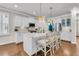 Well-lit kitchen with island seating features modern appliances, white cabinetry, and a seamless transition to the living area at 2219 Kemmerlin St, Johns Island, SC 29455