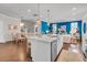 Open-concept kitchen with island seating offers seamless flow to dining and living spaces with elegant design details at 2219 Kemmerlin St, Johns Island, SC 29455