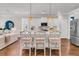 Bright kitchen features a modern island with bar seating, stainless steel appliances, and a seamless view into the living area at 2219 Kemmerlin St, Johns Island, SC 29455