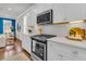 Modern kitchen features white cabinets, stainless steel appliances, and an easy flow into the living room at 2219 Kemmerlin St, Johns Island, SC 29455