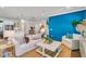 Open-concept living space boasts a stylish blue accent wall that seamlessly connects the living room, dining, and kitchen areas at 2219 Kemmerlin St, Johns Island, SC 29455