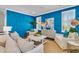Bright living room features a striking blue accent wall and chic, comfortable white furniture at 2219 Kemmerlin St, Johns Island, SC 29455