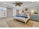 Main bedroom features a ceiling fan, neutral decor, and large windows with plantation shutters at 2219 Kemmerlin St, Johns Island, SC 29455