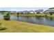 Scenic view of the pond with lush landscaping and neighborhood in the background at 2219 Kemmerlin St, Johns Island, SC 29455