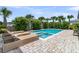 Relaxing backyard pool with spa, surrounded by lush greenery and palm trees on a brick patio at 2219 Kemmerlin St, Johns Island, SC 29455