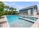 Beautiful backyard pool and spa combo with lush landscaping and a detached garage at 2219 Kemmerlin St, Johns Island, SC 29455