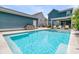 Sparkling backyard pool and spa surrounded by lush landscaping and a patio area at 2219 Kemmerlin St, Johns Island, SC 29455