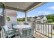 Covered porch with outdoor seating and views of a tree-lined street at 2219 Kemmerlin St, Johns Island, SC 29455