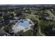 Aerial view showcasing a community swimming pool, surrounded by umbrellas, lounge chairs, and lush greenery at 2241 Dewees Creek Dr, Mount Pleasant, SC 29466