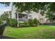 A lush backyard features a manicured lawn and a covered deck at 2241 Dewees Creek Dr, Mount Pleasant, SC 29466