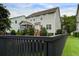 The backyard features a manicured lawn, shrubs, and a privacy fence at 2241 Dewees Creek Dr, Mount Pleasant, SC 29466