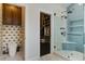 Well-designed bathroom with modern glass shower, unique wall-papered powder room, and access to a custom walk-in closet at 2241 Dewees Creek Dr, Mount Pleasant, SC 29466