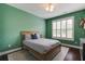 The bedroom has a hardwood bedframe, a lovely area rug, and light from the windows at 2241 Dewees Creek Dr, Mount Pleasant, SC 29466