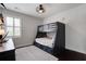 A spacious bedroom features a bunk bed, a window with shutters, and hardwood floors at 2241 Dewees Creek Dr, Mount Pleasant, SC 29466